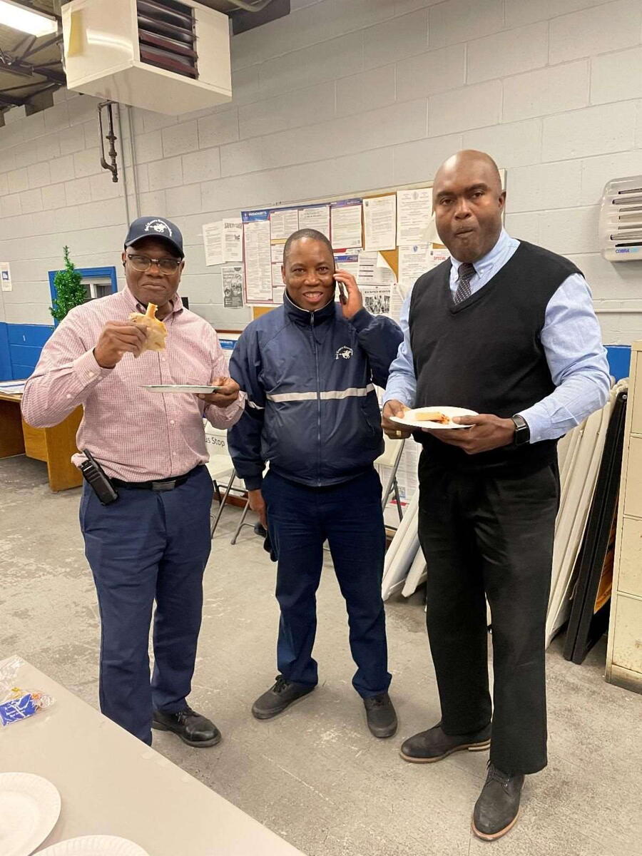 three transit drivers eating pizza