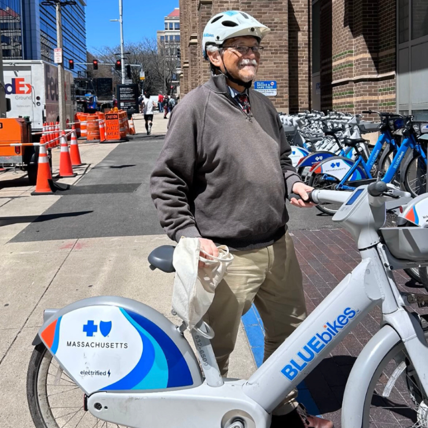 man in a helmet trying an electric bluebike