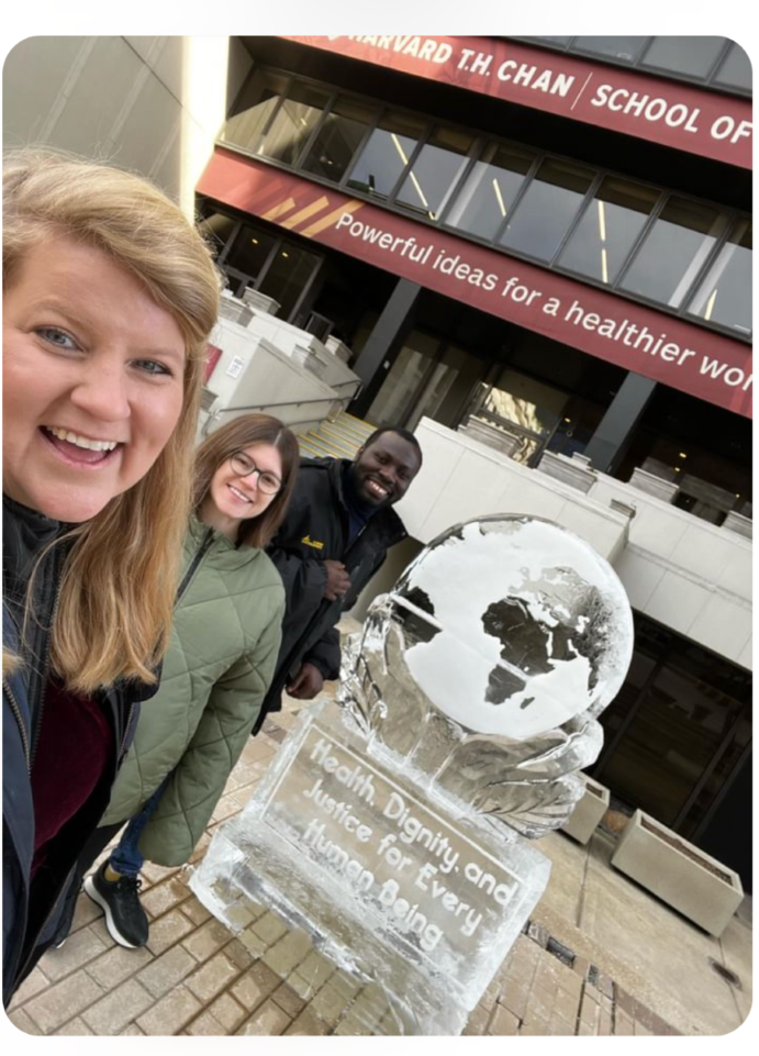 selfie of three smiling people with Harvard TH Chan ice sculpture